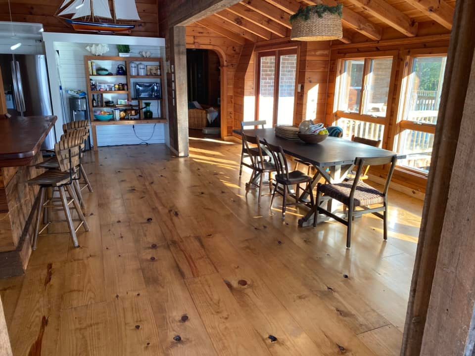 Large open concept kitchen area with rustic wood flooring