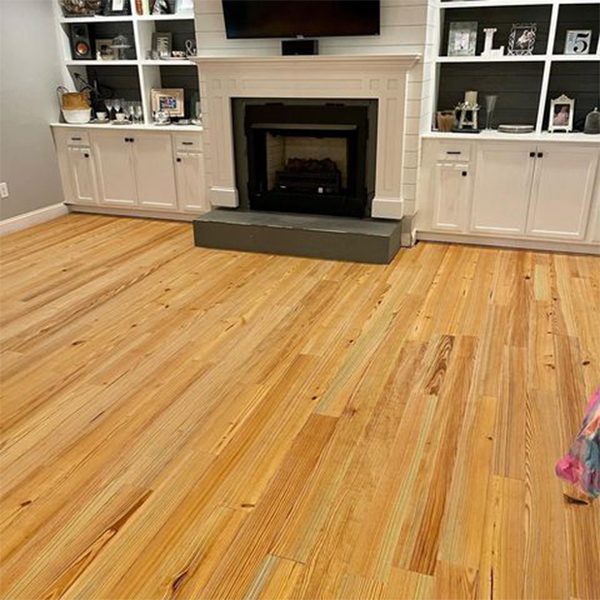 Heart Pine Flooring in a Living Room with a Fireplace and Built In Shelves