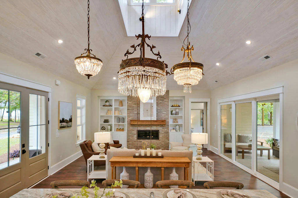 View of a large living room with white built ins and a fireplace