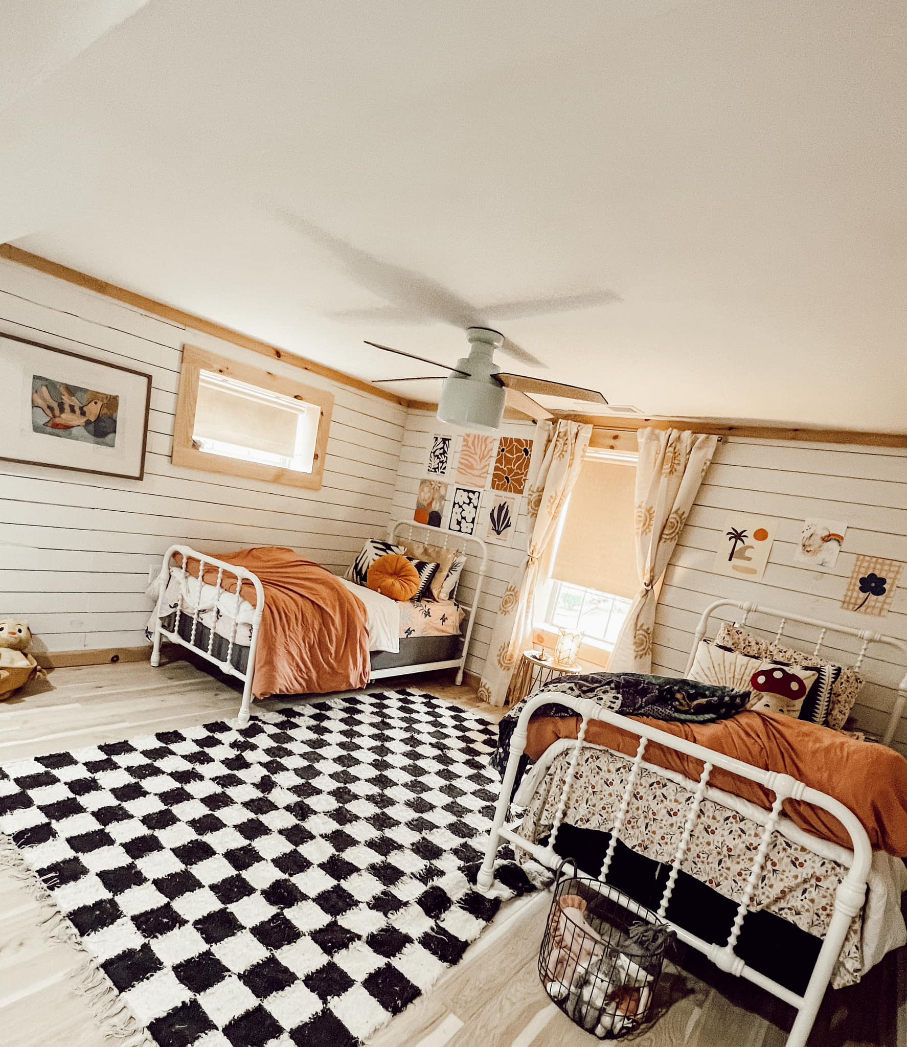 Bedroom with two twin beds and white shiplap walls