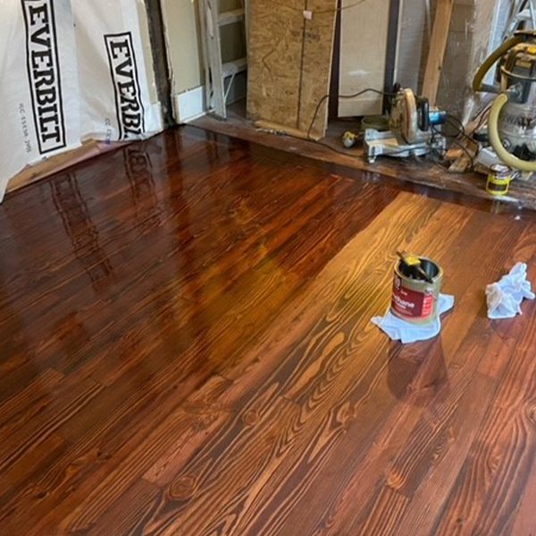 White wood flooring in a kitchen with gray cabinets