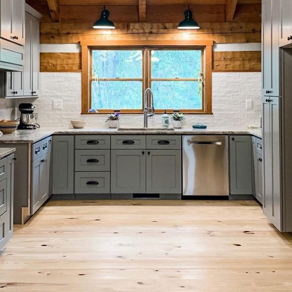 White wood flooring in a kitchen with gray cabinets
